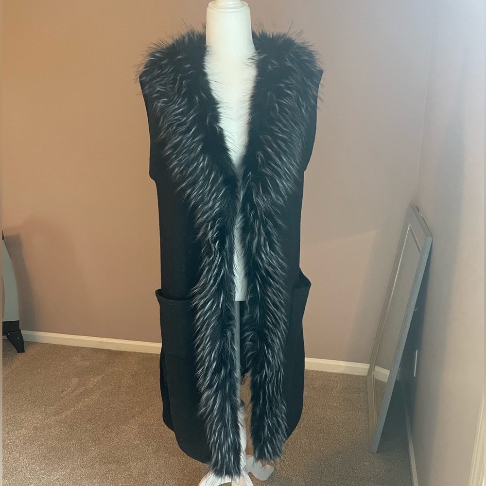 Faux fur knee length vest. Front closure. No flaws, no tears, no stains.